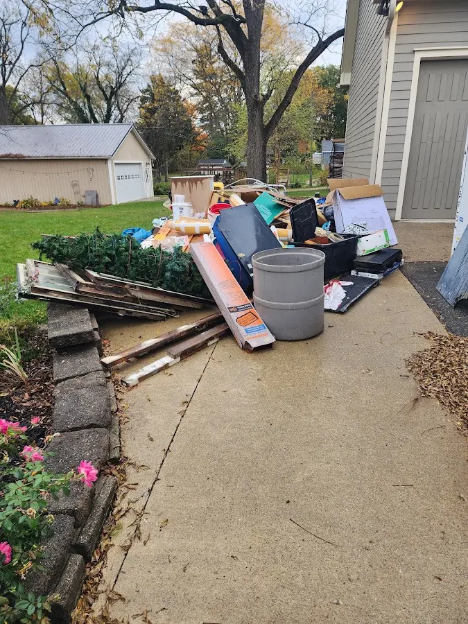 Dumpster being loaded with debris for 12 Yard Dumpster Rental in Haring